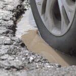 6_Alloy-Wheel-And-Tire-In-A-Pothole-Closeup.jpg