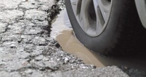6_Alloy-Wheel-And-Tire-In-A-Pothole-Closeup.jpg