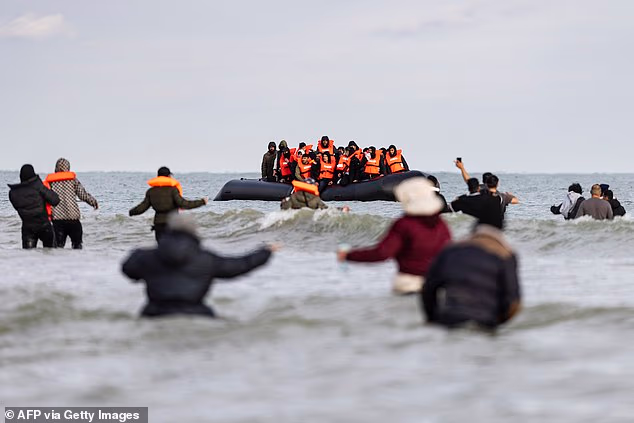 95665549-15469819-Migrants_wave_to_a_smuggler_s_boat_in_an_attempt_to_cross_the_En-a-1_1768559773695.avif