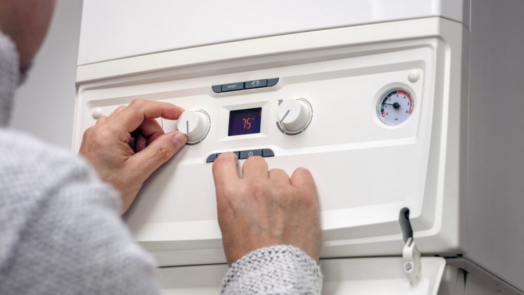adjusting-thermostat-setting-domestic-home-942628766.jpg