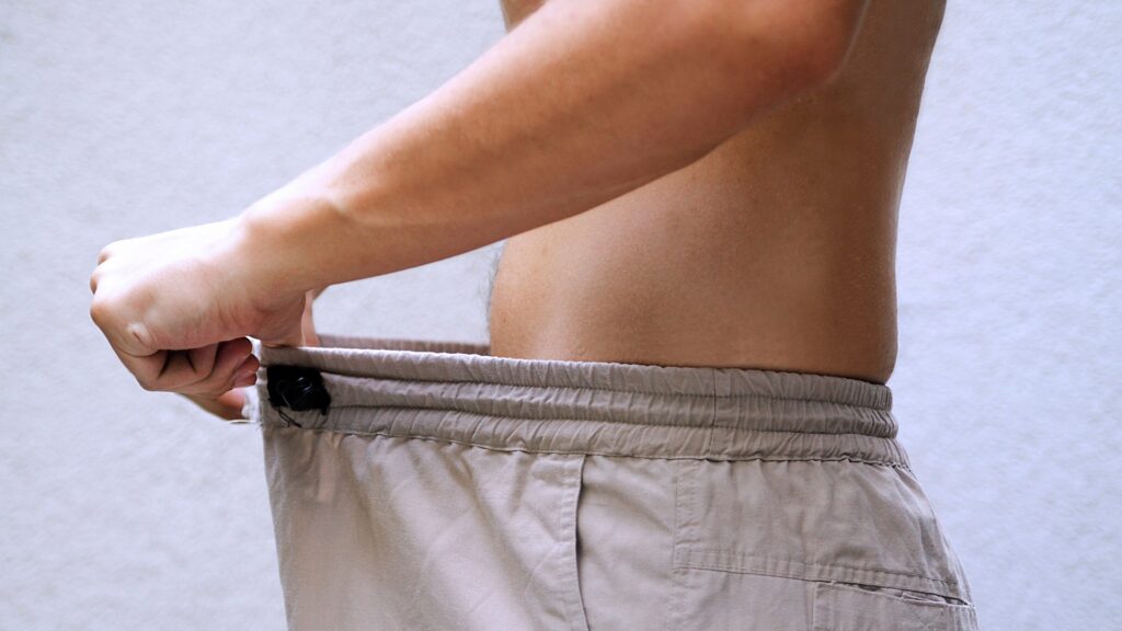 man-diet-comparing-waist-size-1049379773.jpg