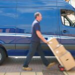 2_Blurred-view-of-Caucasian-delivery-man-wheeling-packages.jpg
