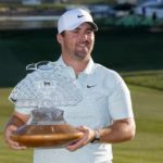 Chris-Gotterup-smiles-as-he-holds-up-the-winners-trophy-after-defeating-Hideki-Matsuyama-in-a-one-ho.avif