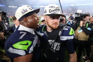 Sam-Darnold-and-Uchenna-Nwosu-of-the-Seattle-Seahawks-celebrate.jpeg