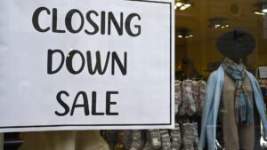 closing-sign-shopfront-window-store-1055822661.jpg