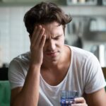 young-man-suffering-strong-headache-1055734197.jpg